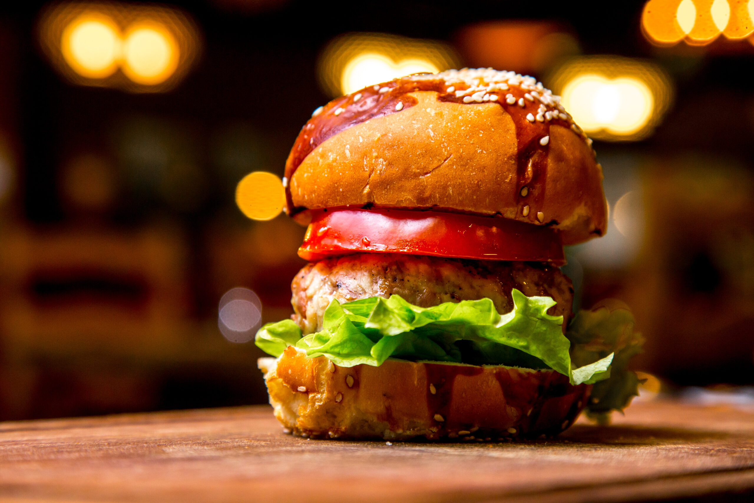 chicken burger wooden board side view scaled